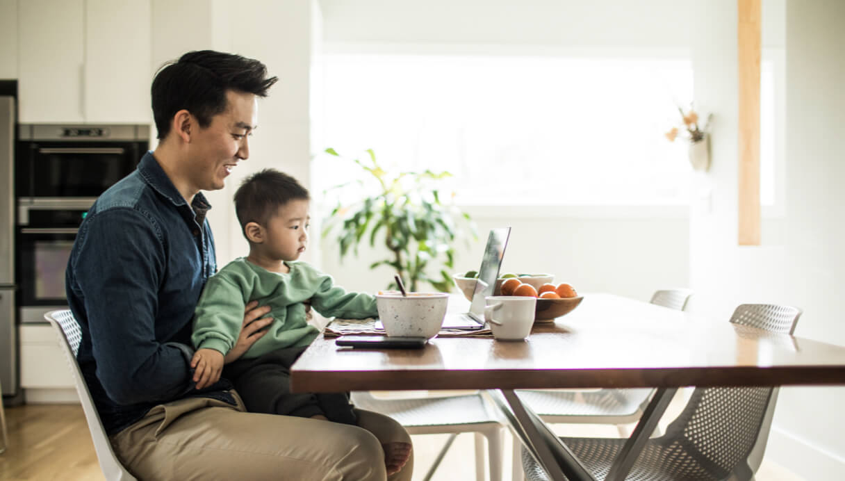 Father and son looking at laptop